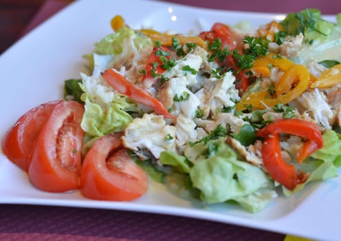 Salad with white fish green salad rice and tomatos