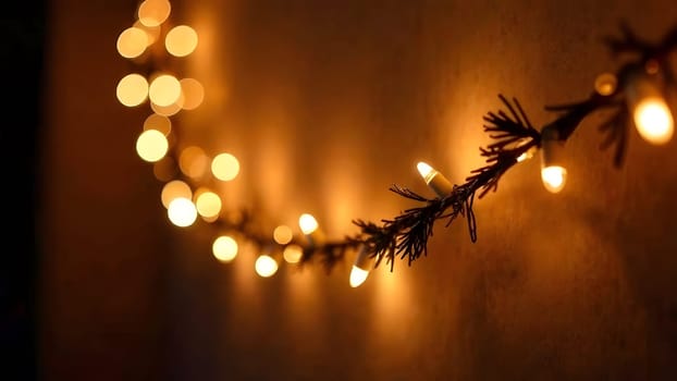 Glowing fairy lights strung on Christmas garlands sway gently in this image, radiating a warm golden and white holiday glow.