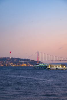 An incredibly serene and picturesque sunset view featuring a beautiful bridge across the calm water