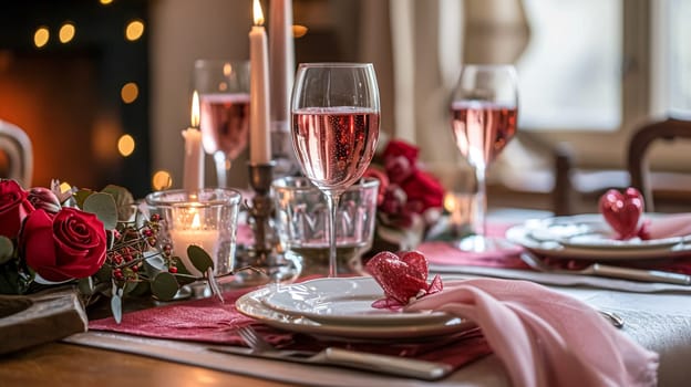 Festive table setting with candles and arrangement of beautiful red flowers. Holiday concept. High quality photo