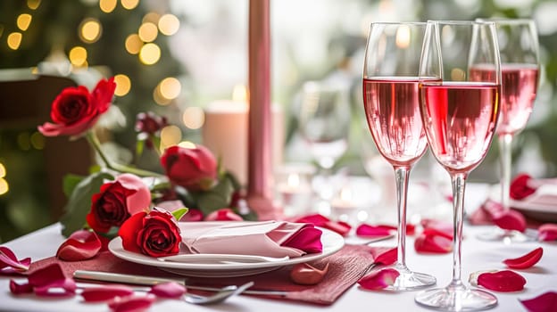 Festive table setting with candles and arrangement of beautiful red flowers. Holiday concept. High quality photo