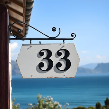 number 33 sign pointer address near the house. High quality photo