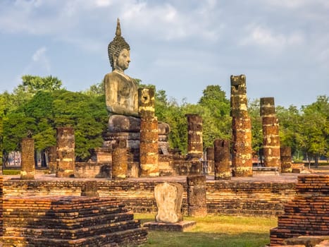Buddha statue at Wat Mahathat Maha That temple by day, Sukhothai, Thailand