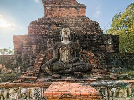 Buddha statue at Wat Mahathat Maha That temple by day, Sukhothai, Thailand