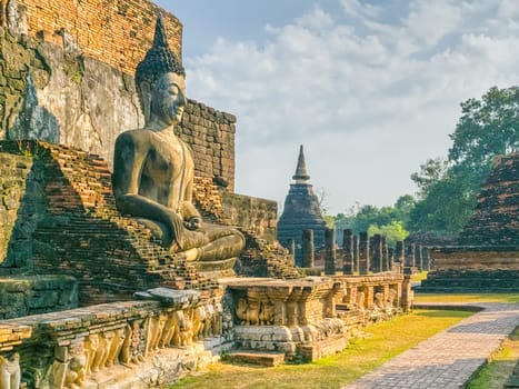 Buddha statue at Wat Mahathat Maha That temple by day, Sukhothai, Thailand