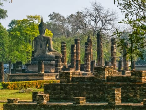 Buddha statue at Wat Mahathat Maha That temple by day, Sukhothai, Thailand