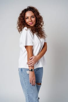 Young woman posing confidently in casual attire against a neutral backdrop close up