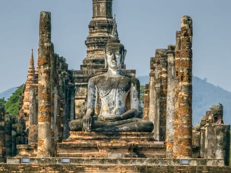 Buddha statue at Wat Mahathat Maha That temple by day, Sukhothai, Thailand