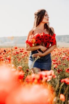 Woman poppies field. portrait of a happy woman with long hair in a poppy field and enjoying the beauty of nature in a warm summer day