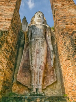 Buddha statue at Wat Mahathat Maha That temple by day, Sukhothai, Thailand