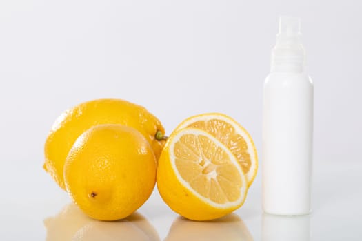 Bright, juicy lemons placed alongside a refreshing citrus spray, offering various health and wellness solutions