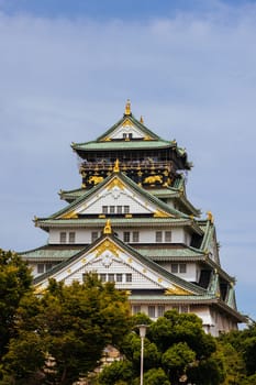 OSAKA, JAPAN - SEPTEMBER 25 2024: The iconic Osaka Castle and lush surrounds on a warm clear autumn day in Osaka, Japan on September 25th 2024