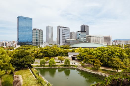 OSAKA, JAPAN - SEPTEMBER 25 2024: Views towards the Shiromi business district and Osaka-Jo Hall from Osaka Castle on a warm autumn day in Osaka, Japan on September 25th 2024