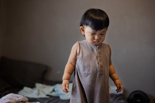 Child in pajamas in the bedroom.