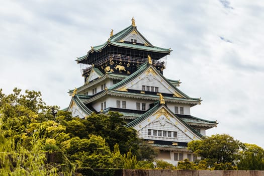 OSAKA, JAPAN - SEPTEMBER 25 2024: The iconic Osaka Castle and lush surrounds on a warm clear autumn day in Osaka, Japan on September 25th 2024
