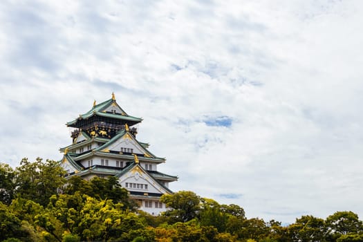 OSAKA, JAPAN - SEPTEMBER 25 2024: The iconic Osaka Castle and lush surrounds on a warm clear autumn day in Osaka, Japan on September 25th 2024
