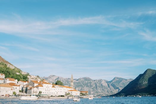 Old stone houses with a bell tower of the church of the town of Perast on the seashore. Montenegro. High quality photo