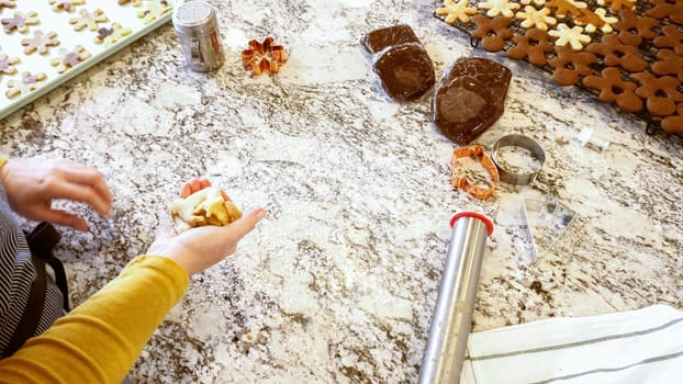 Using an adjustable rolling pin to roll out gingerbread cookie dough on the elegant marble counter in a modern kitchen, getting ready for festive holiday baking.