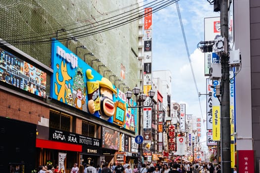OSAKA, JAPAN - SEPTEMBER 24 2024: Osaka's famous Dotonbori area with many restaurants and iconic food signage at dusk in Osaka, Japan