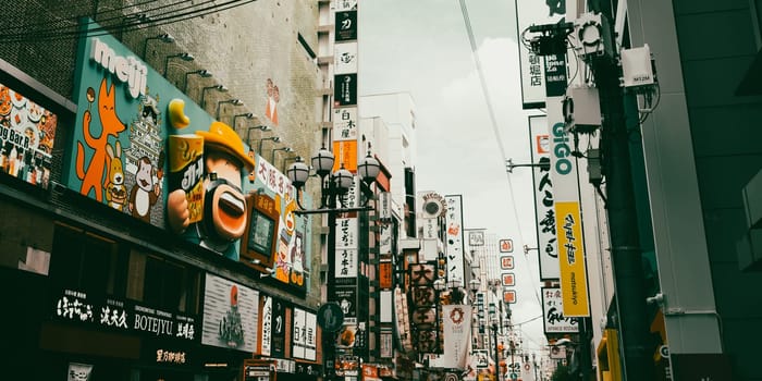 OSAKA, JAPAN - SEPTEMBER 24 2024: Osaka's famous Dotonbori area with many restaurants and iconic food signage at dusk in Osaka, Japan