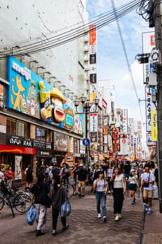 OSAKA, JAPAN - SEPTEMBER 24 2024: Osaka's famous Dotonbori area with many restaurants and iconic food signage at dusk in Osaka, Japan