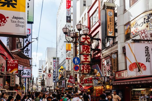 OSAKA, JAPAN - SEPTEMBER 24 2024: Osaka's famous Dotonbori area with many restaurants and iconic food signage at dusk in Osaka, Japan