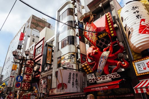 OSAKA, JAPAN - SEPTEMBER 24 2024: Osaka's famous Dotonbori area with many restaurants and iconic food signage at dusk in Osaka, Japan