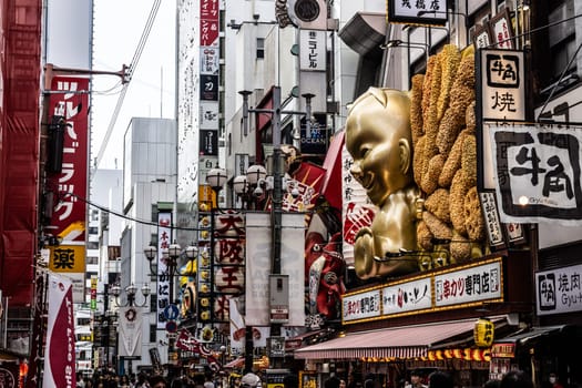 OSAKA, JAPAN - SEPTEMBER 24 2024: Osaka's famous Dotonbori area with many restaurants and iconic food signage at dusk in Osaka, Japan