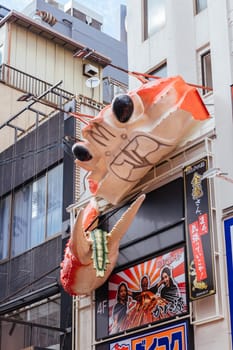 OSAKA, JAPAN - SEPTEMBER 24 2024: Osaka's famous Dotonbori area with many restaurants and iconic food signage, including moving lobsters in Osaka, Japan