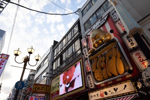 OSAKA, JAPAN - SEPTEMBER 24 2024: Osaka's famous Dotonbori area with many restaurants and iconic food signage at dusk in Osaka, Japan