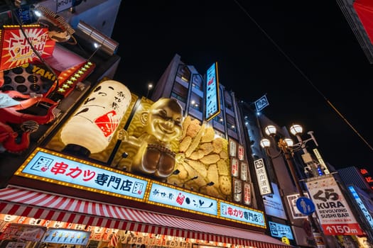 OSAKA, JAPAN - SEPTEMBER 24 2024: Osaka's famous Dotonbori area with many restaurants and iconic food signage, including this golden baby in Osaka, Japan