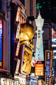 OSAKA, JAPAN - SEPTEMBER 24 2024: Osaka's famous Dotonbori area with many restaurants and iconic food signage, including this golden baby in Osaka, Japan