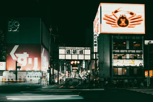 OSAKA, JAPAN - SEPTEMBER 25 2024: Osaka's famous Dotonbori area with many restaurants and iconic food signage at dusk in Osaka, Japan