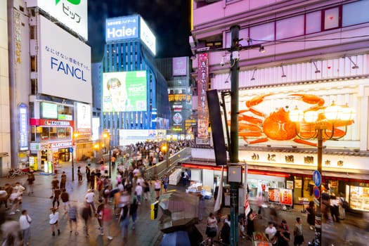 OSAKA, JAPAN - SEPTEMBER 25 2024: Osaka's famous Dotonbori area with many restaurants and iconic food signage at dusk in Osaka, Japan