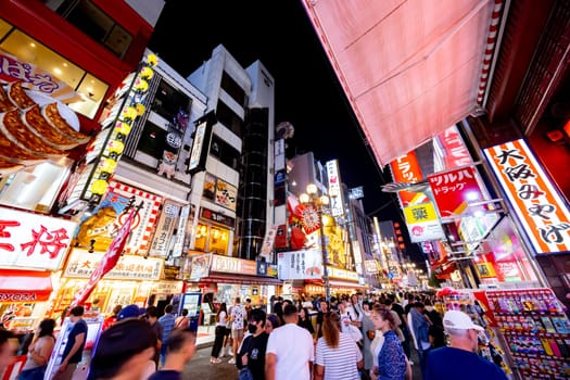OSAKA, JAPAN - SEPTEMBER 25 2024: Osaka's famous Dotonbori area with many restaurants and iconic food signage at dusk in Osaka, Japan
