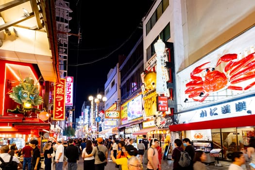 OSAKA, JAPAN - SEPTEMBER 25 2024: Osaka's famous Dotonbori area with many restaurants and iconic food signage at dusk in Osaka, Japan