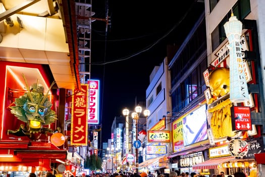 OSAKA, JAPAN - SEPTEMBER 25 2024: Osaka's famous Dotonbori area with many restaurants and iconic food signage at dusk in Osaka, Japan