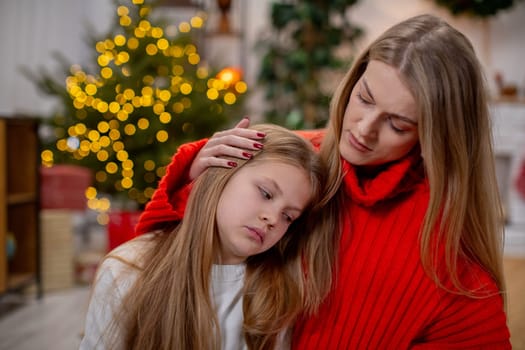 A warm scene capturing a loving mother comforting her caring daughter during the festive season of joy