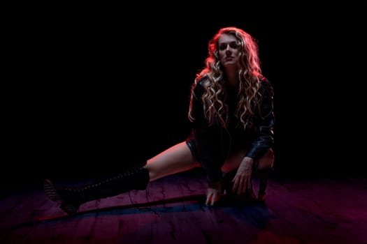 A stunning and striking portrait that beautifully showcases a woman posed dramatically against vibrant lighting
