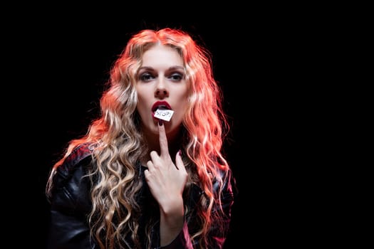 This captivating portrait features a model with curly hair, bold makeup, and an expressive pose, exuding an edgy vibe