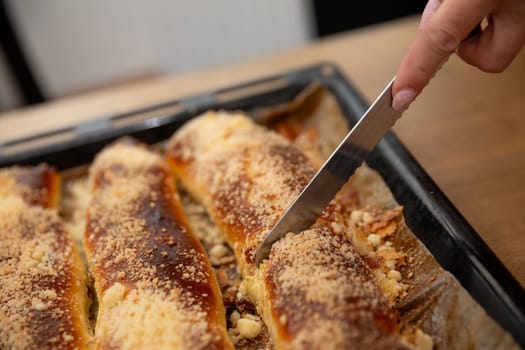 A closeup of a delicious baked dessert being sliced, showing a crunchy topping and a goldenbrown crust