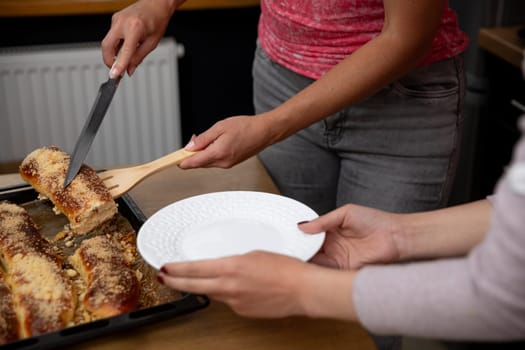 A person serves delicious enchiladas on a decorative plate in a warm, inviting kitchen filled with love