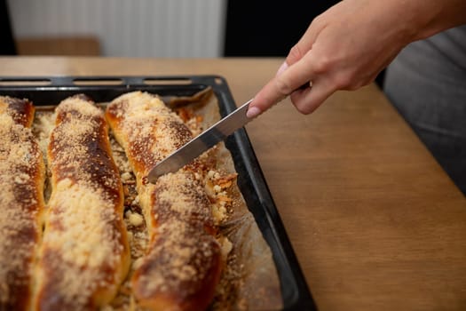 A freshly baked artisan bread loaf is sliced on a wooden board, showcasing its golden crust and delicious texture