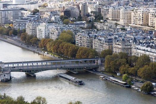 A breathtaking aerial view of Paris that beautifully highlights the Seine River, its bridges, and urban architecture