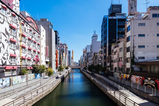 OSAKA, JAPAN - SEPTEMBER 26 2024: Dotonboru River view near the trendy and fashionable Amerikamura district on a clear autumn day in Osaka, Japan