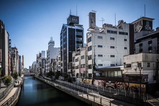 OSAKA, JAPAN - SEPTEMBER 26 2024: Dotonboru River view near the trendy and fashionable Amerikamura district on a clear autumn day in Osaka, Japan