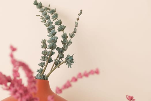 A stylish arrangement of colorful dried flowers displayed against a neutral backdrop
