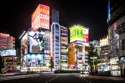 TOKYO, JAPAN, SEPTEMBER 16 2024: Neon signs illuminate with traffic in Tokyo’s busy Shinjuku neighborhood at night in Japan