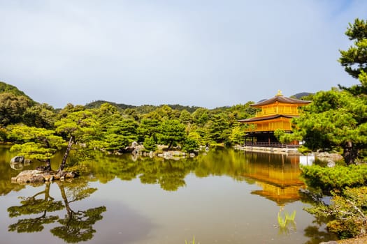 The world famous Kinkakuji Temple (The Golden Pavilion) in Kyoto, Japan on a warm autumn morning
