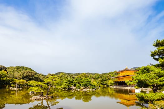 The world famous Kinkakuji Temple (The Golden Pavilion) in Kyoto, Japan on a warm autumn morning